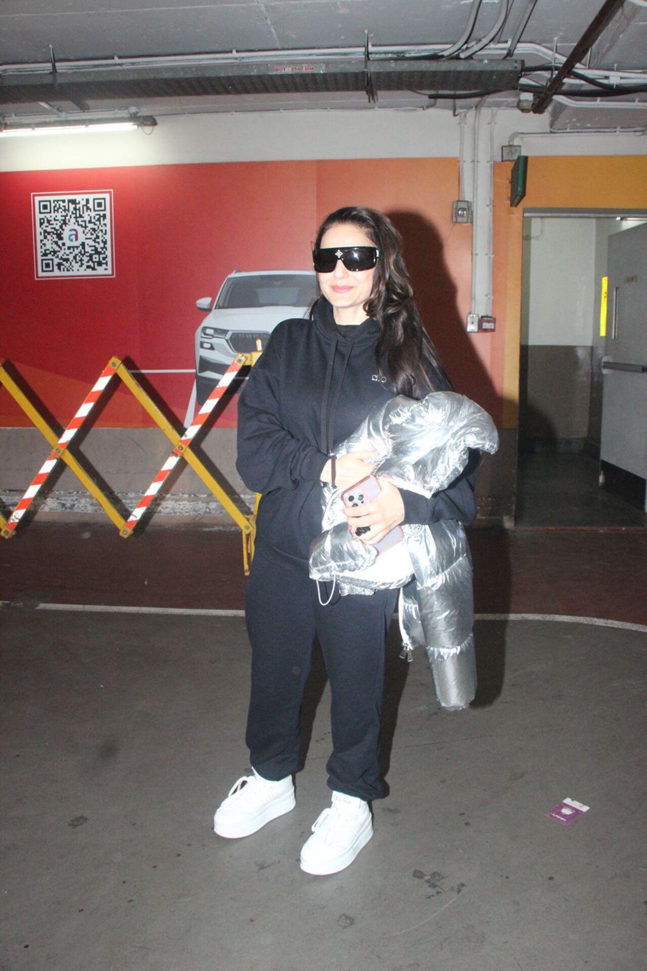 Ameesha Patel kept it comfy yet chic in an all-black hoodie and joggers combo. She styled her look with chunky white sneakers and oversized black sunglasses.